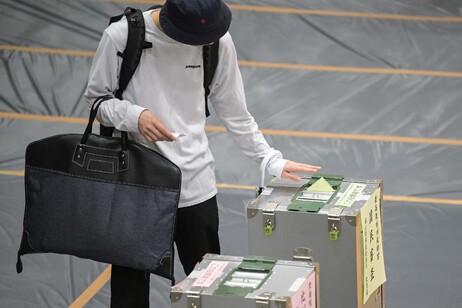 A man votes during the general election at a polling station set up at a local school in Tokyo